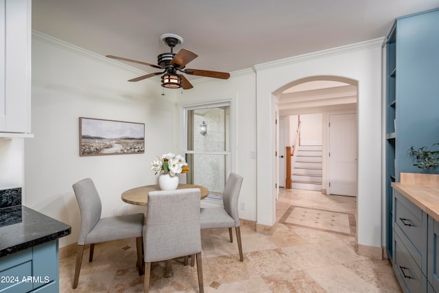 dining space featuring ceiling fan and crown molding