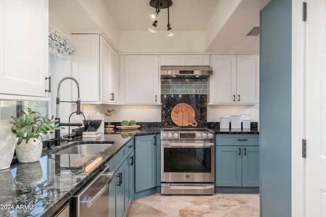 kitchen featuring white cabinetry, stainless steel appliances, exhaust hood, and dark stone counters