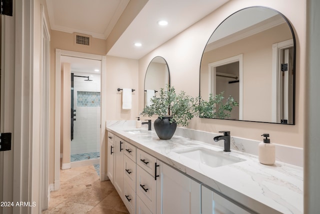 bathroom with crown molding, tile patterned flooring, vanity, and tiled shower