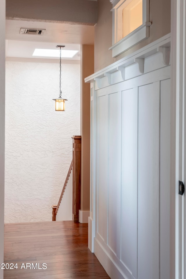 corridor with hardwood / wood-style floors