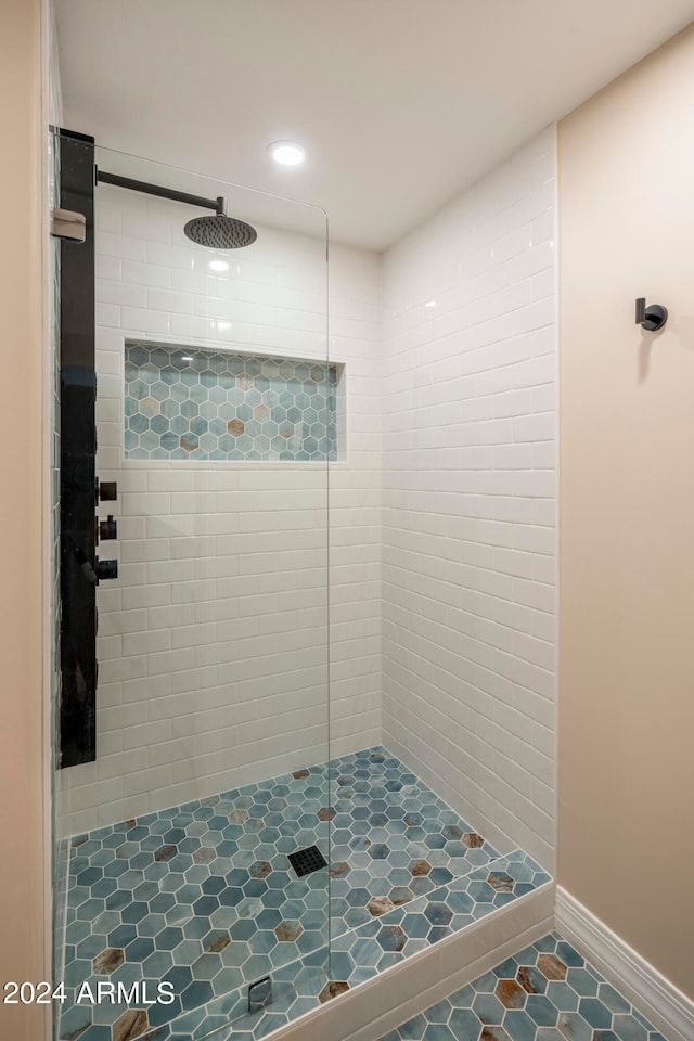 bathroom featuring a tile shower and tile patterned floors