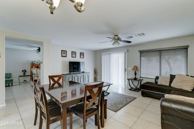 dining area featuring light tile patterned floors, visible vents, and ceiling fan