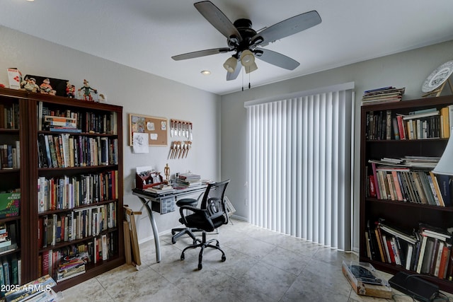 tiled home office featuring baseboards and ceiling fan