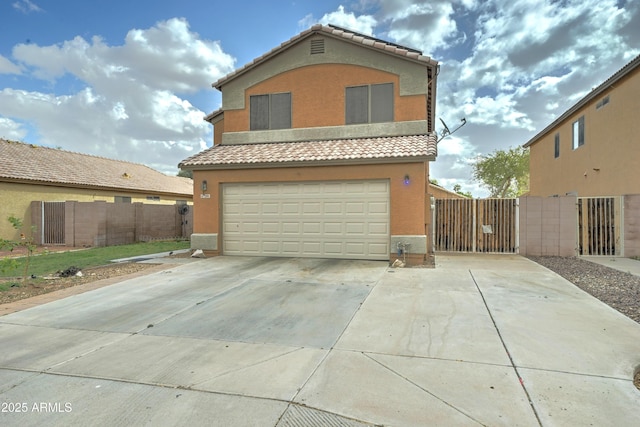 view of front of house with stucco siding, concrete driveway, an attached garage, and a tile roof