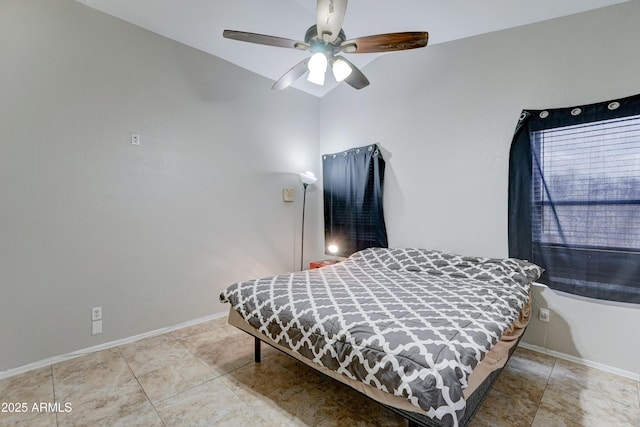 bedroom featuring tile patterned floors, a ceiling fan, and baseboards