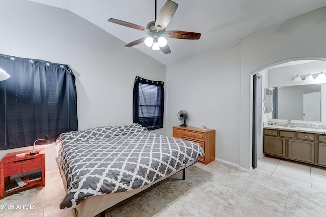 bedroom featuring a sink, baseboards, light tile patterned floors, and vaulted ceiling