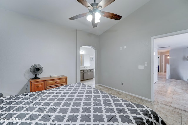 unfurnished bedroom featuring a ceiling fan, a sink, arched walkways, baseboards, and vaulted ceiling