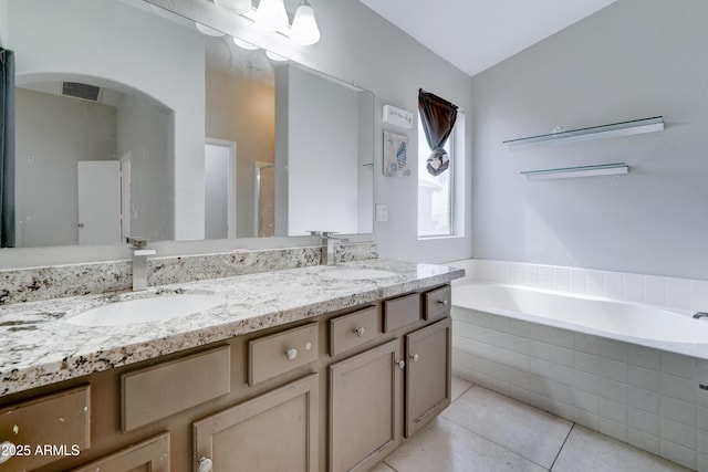 bathroom with tile patterned floors, visible vents, a bath, and a sink