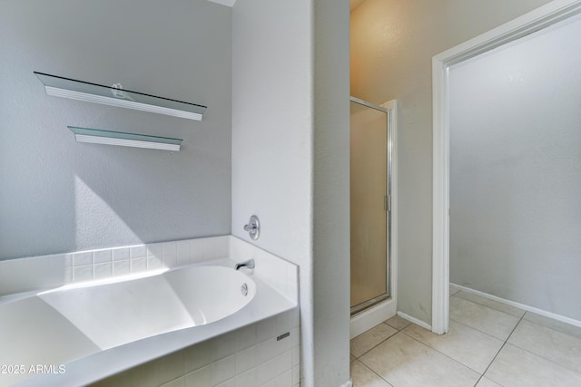 full bathroom with a garden tub, a stall shower, and tile patterned flooring