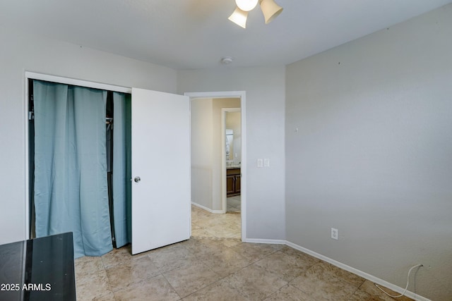 unfurnished bedroom with a closet and baseboards