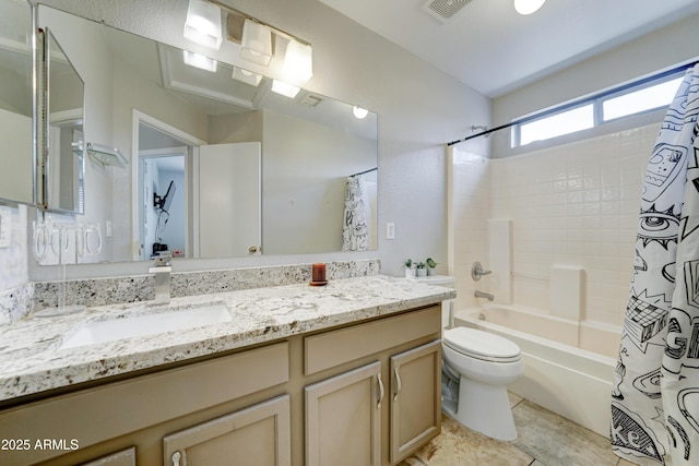 bathroom with visible vents, toilet, vanity, and shower / tub combo with curtain