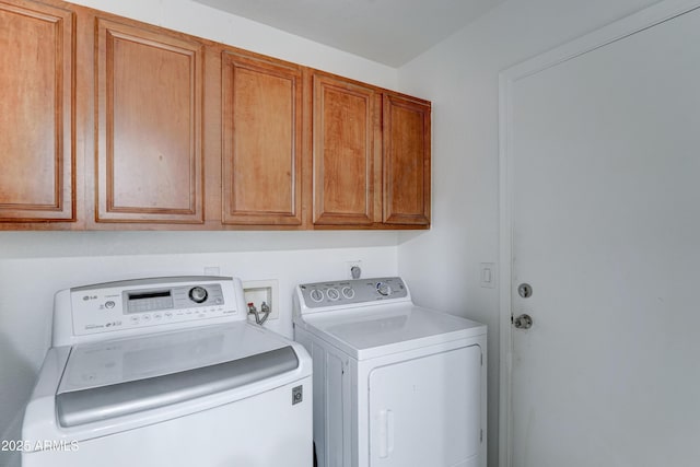 laundry area with cabinet space and independent washer and dryer