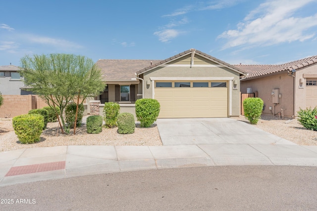 5957 N 89th Dr, Glendale, AZ 85305 - ranch-style house with an attached garage, concrete driveway, a tile roof, and stucco siding