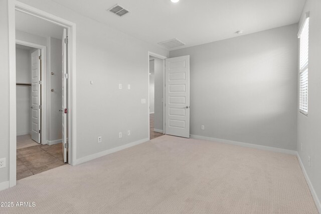 5957 N 89th Dr, Glendale, AZ 85305 - unfurnished bedroom with carpet, baseboards, and a spacious closet