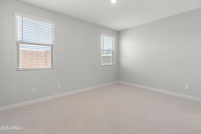5957 N 89th Dr, Glendale, AZ 85305 - spare room featuring light colored carpet, baseboards, and recessed lighting