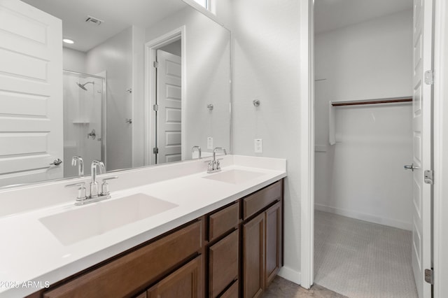 5957 N 89th Dr, Glendale, AZ 85305 - full bathroom with a spacious closet, double vanity, a shower, and baseboards
