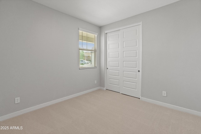 5957 N 89th Dr, Glendale, AZ 85305 - unfurnished bedroom with light carpet, baseboards, and a closet