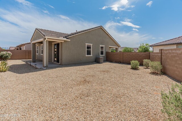 5957 N 89th Dr, Glendale, AZ 85305 - back of property with a tile roof, a fenced backyard, stucco siding, cooling unit, and a patio area