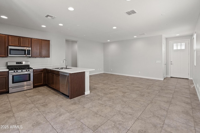 5957 N 89th Dr, Glendale, AZ 85305 - kitchen with stainless steel appliances, a sink, recessed lighting, light countertops, and a peninsula