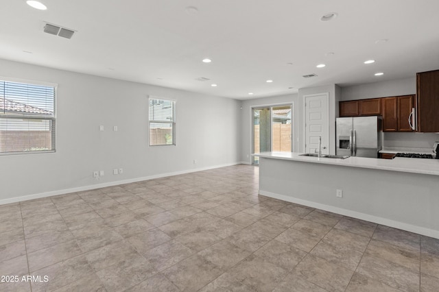 5957 N 89th Dr, Glendale, AZ 85305 - kitchen featuring stainless steel fridge with ice dispenser, recessed lighting, light countertops, stove, and baseboards