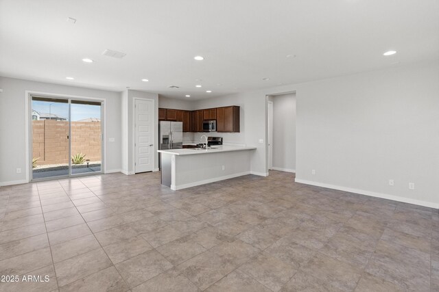 5957 N 89th Dr, Glendale, AZ 85305 - unfurnished living room with a sink, recessed lighting, and baseboards