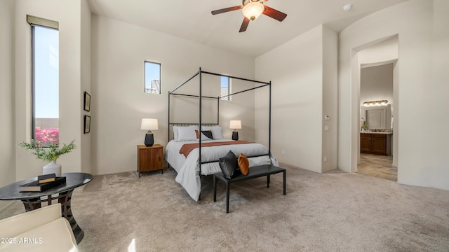 bedroom with light colored carpet and ensuite bath
