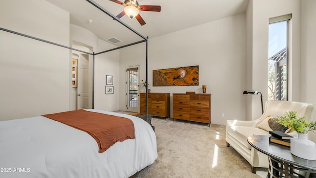 bedroom with light carpet, multiple windows, ceiling fan, and visible vents
