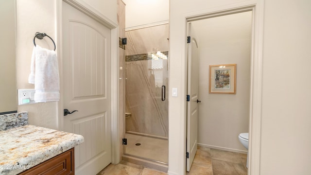 bathroom with toilet, vanity, and a stall shower
