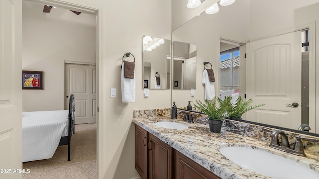 bathroom featuring double vanity, a sink, and a ceiling fan