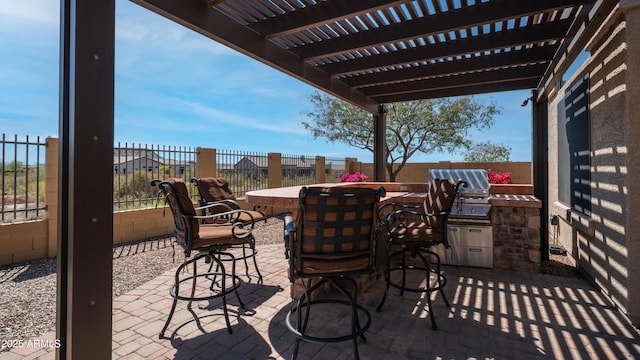 view of patio featuring a fenced backyard, area for grilling, exterior kitchen, and a pergola