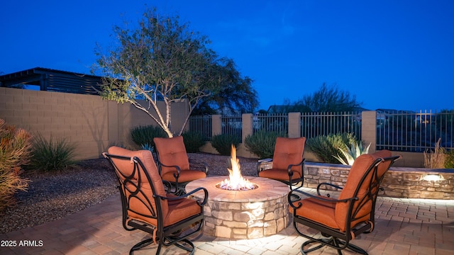 view of patio / terrace with fence private yard and a fire pit