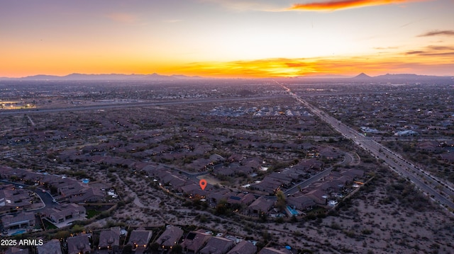 aerial view at dusk with a mountain view and a residential view