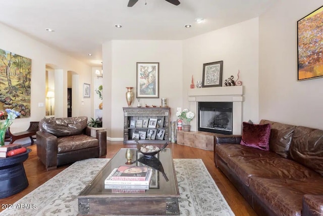 living room featuring hardwood / wood-style floors and ceiling fan