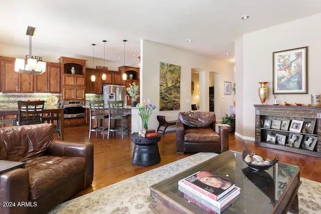 living room with hardwood / wood-style flooring and a chandelier