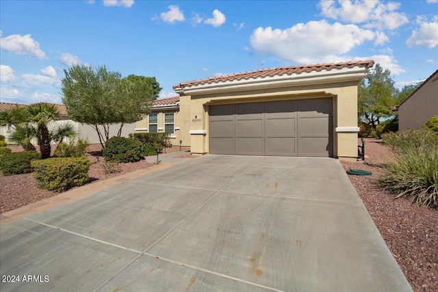 mediterranean / spanish home featuring a garage