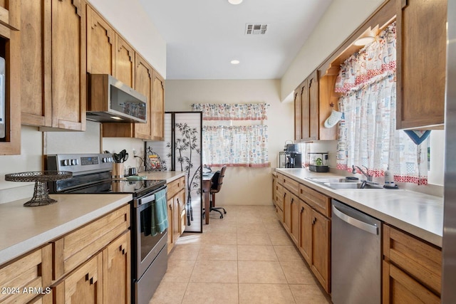 kitchen featuring sink, light tile patterned floors, and appliances with stainless steel finishes