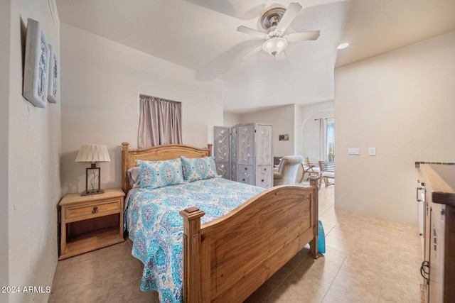 tiled bedroom with ceiling fan