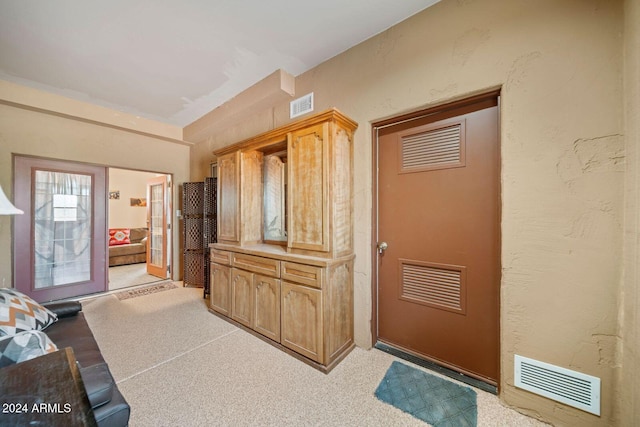 kitchen featuring light colored carpet