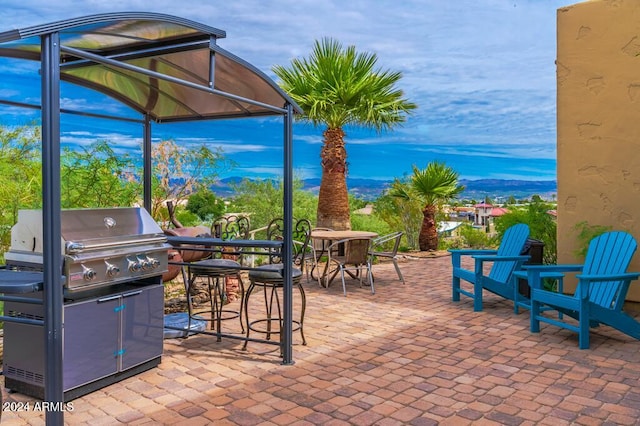 view of patio / terrace with a grill and a mountain view