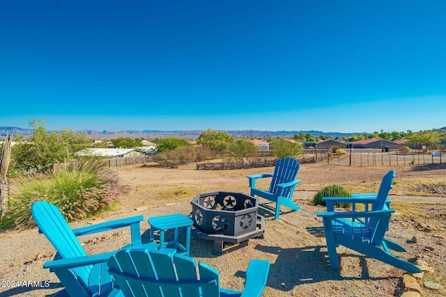 view of patio featuring a mountain view and an outdoor fire pit