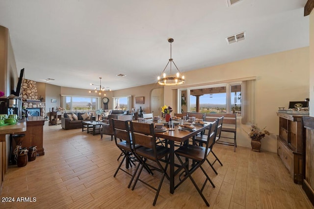 dining room featuring a chandelier, a healthy amount of sunlight, and light hardwood / wood-style floors