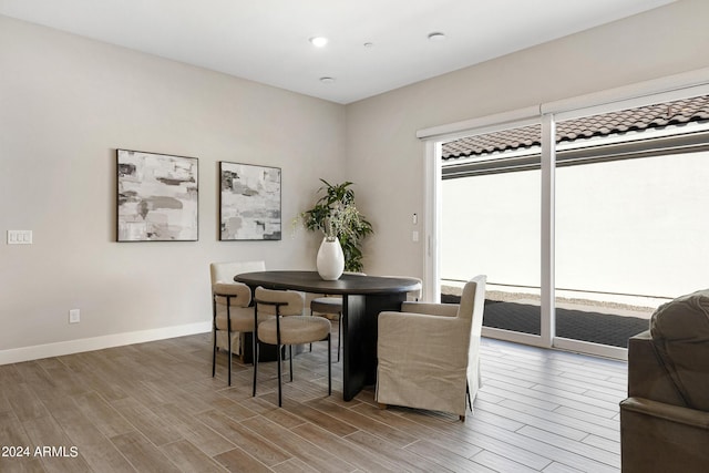 dining room with plenty of natural light and hardwood / wood-style flooring