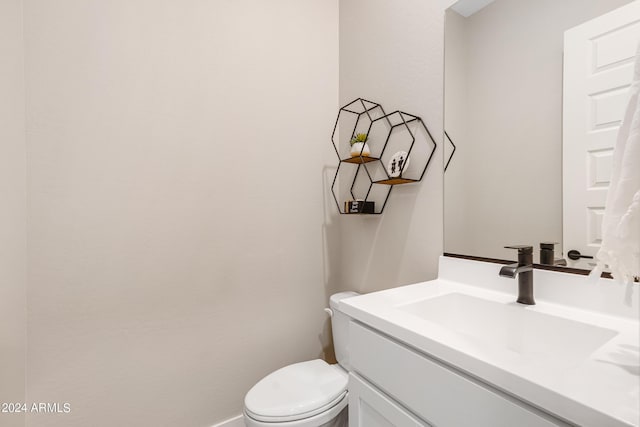 bathroom featuring toilet and vanity