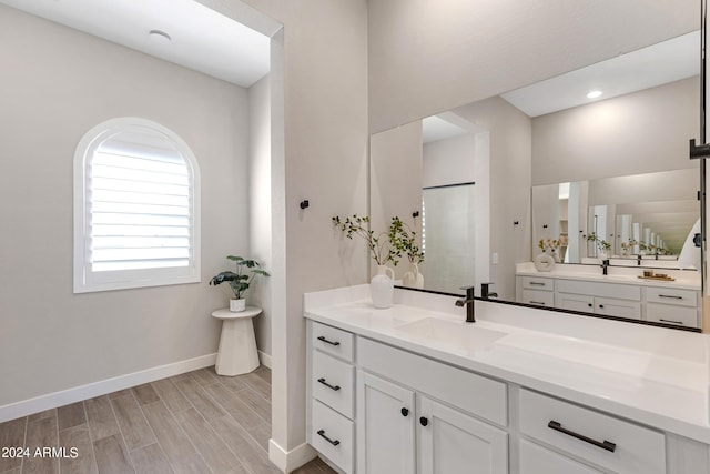 bathroom with vanity and hardwood / wood-style flooring