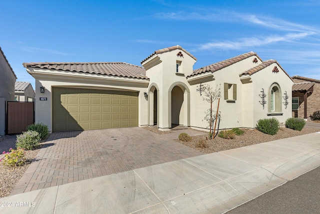 mediterranean / spanish-style home with a garage