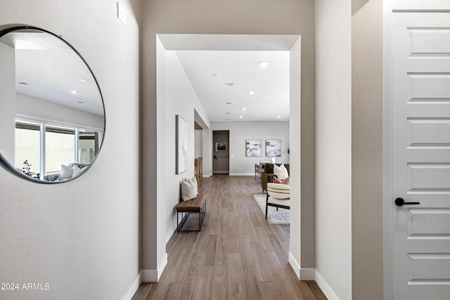 corridor with light hardwood / wood-style floors