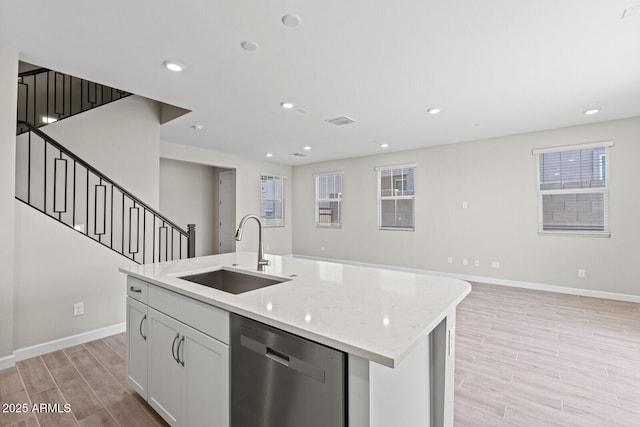 21047 N 58th Way, Phoenix, AZ 85054 - kitchen featuring dishwasher, a sink, light wood-style flooring, baseboards, and recessed lighting