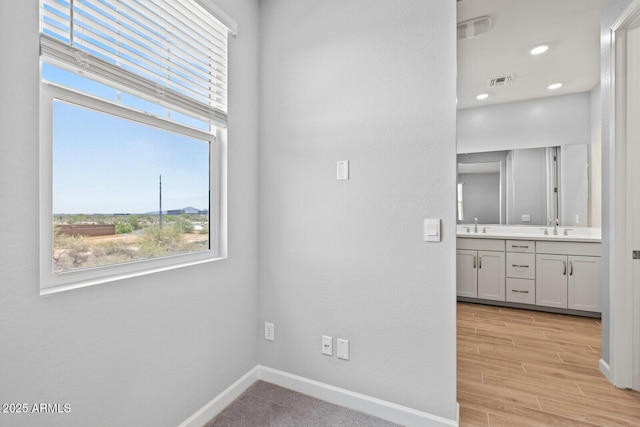 21047 N 58th Way, Phoenix, AZ 85054 - unfurnished room with plenty of natural light, baseboards, a sink, and recessed lighting