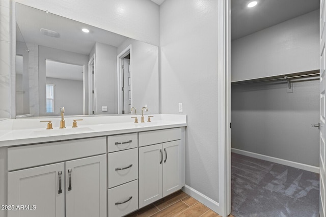 21047 N 58th Way, Phoenix, AZ 85054 - full bath with double vanity, a walk in closet, baseboards, recessed lighting, and wood finished floors