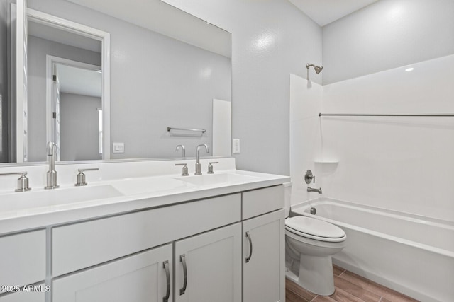 21047 N 58th Way, Phoenix, AZ 85054 - bathroom featuring toilet, wood finished floors, double vanity, and washtub / shower combination